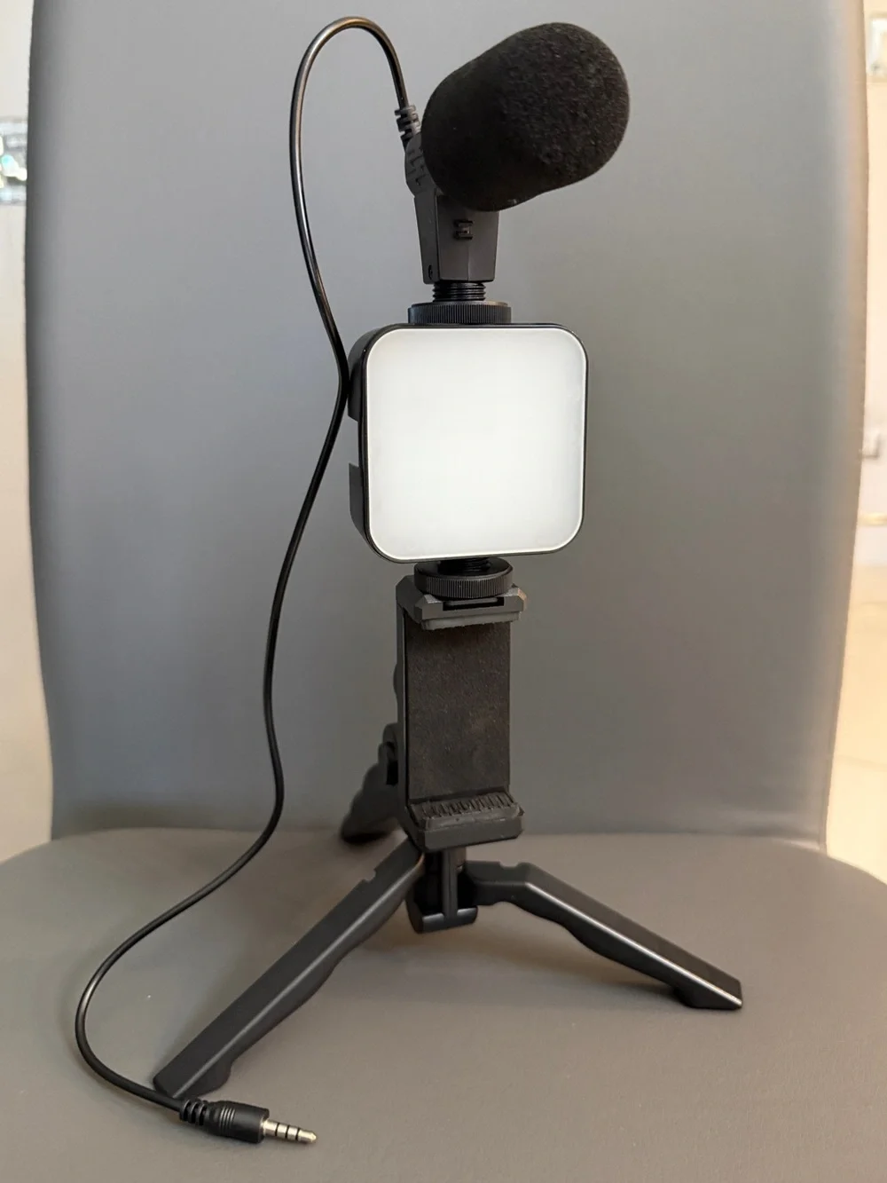 Portable Black Lavalier Microphone Kit with LED Fill Light and Mini Tripod